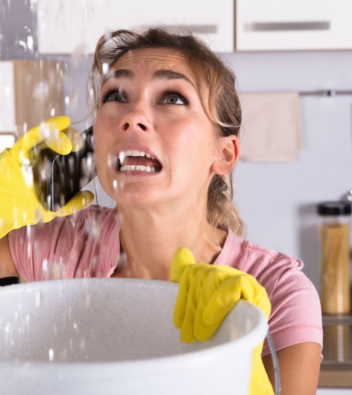 Woman calling plumber during leak